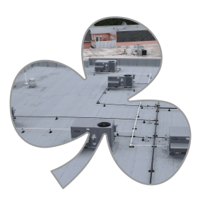 A shamrock outline with a commercial roof inside of it.